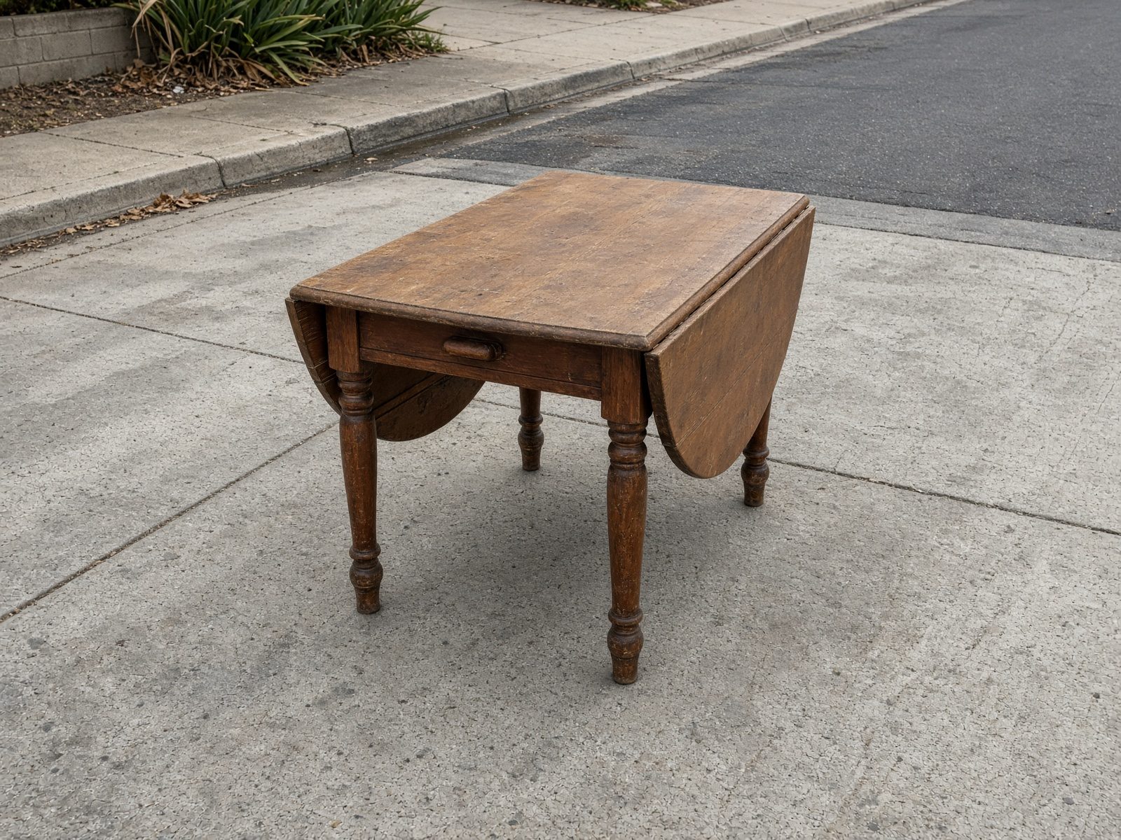 Drop-leaf table staged for San Diego furniture removal